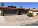 Well-maintained single-story home with a spacious driveway, desert landscaping, and a classic facade at 2130 W Devonshire St, Mesa, AZ 85201