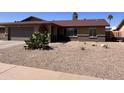 Desert-landscaped front yard showcasing native plants and a well-kept appearance, offering low-maintenance appeal at 2130 W Devonshire St, Mesa, AZ 85201