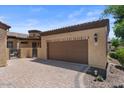 Attached two-car garage with a private gate and landscaped yard at 2145 N 88Th St, Mesa, AZ 85207