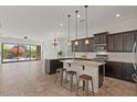 Open concept kitchen features modern appliances and island with seating at 2145 N 88Th St, Mesa, AZ 85207