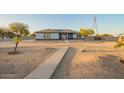 Inviting single-story home with a well-maintained desert front yard at 22626 W Gibson Ln, Buckeye, AZ 85326