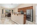 Open kitchen featuring a peninsula bar, stainless steel appliances, and adjacent dining area at 2329 E Ebony Dr, Chandler, AZ 85286
