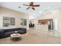 Bright living room showcasing an open floor plan, leading into a dining area and kitchen with stainless steel appliances at 2329 E Ebony Dr, Chandler, AZ 85286