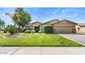 Charming home with a well-manicured lawn, mature trees, and a two-car garage at 2585 E Morgan Dr, Gilbert, AZ 85295