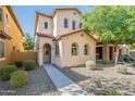 Attractive two-story home with arched windows, low-maintenance landscaping, and a welcoming walkway at 25925 N 53Rd Dr, Phoenix, AZ 85083