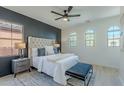 Relaxing main bedroom with a tufted headboard, stylish bench, and bright windows at 25925 N 53Rd Dr, Phoenix, AZ 85083