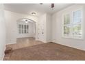 Inviting living room features neutral carpeting, white walls and arched doorways at 28967 N 124Th Ave, Peoria, AZ 85383