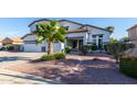 Charming front yard with stone walkway, desert landscaping, and a mature palm tree at 2977 E County Down Dr, Chandler, AZ 85249