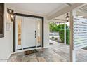 Inviting front porch with decorative tile flooring, stylish lighting, and a welcoming entrance at 3517 E Monterosa St, Phoenix, AZ 85018