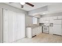 Bright kitchen featuring a window, a set of white appliances, and a sink at 3605 W Bethany Home Rd # 7, Phoenix, AZ 85019