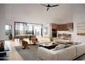 Bright open concept living room with hardwood floors, modern furnishings, and large sliding glass doors to outdoors at 3743 E Hazelwood St, Phoenix, AZ 85018