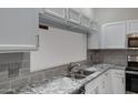 Beautiful kitchen features granite countertops, stainless appliances, and crisp white cabinetry at 4165 E Huntington Dr, Phoenix, AZ 85040