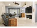 Bright living room features vaulted ceilings, a fireplace, and a comfortable seating arrangement at 441 E Encinas Ave, Gilbert, AZ 85234