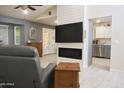 Open-concept living room with modern fireplace and access to the kitchen at 441 E Encinas Ave, Gilbert, AZ 85234