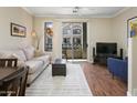 Comfortable living area with a modern sofa, entertainment center, and sliding glass doors to balcony at 4455 E Paradise Village Pkwy # 1051, Phoenix, AZ 85032