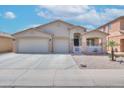 Beautiful home with a desert landscape, a two-car garage, and a charming white picket fence at 46141 W Amsterdam Rd, Maricopa, AZ 85139