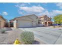 Attractive single-Gathering house with a two-car garage, desert landscaping and a driveway at 46141 W Amsterdam Rd, Maricopa, AZ 85139