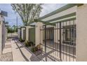 Inviting outdoor entryway showcasing a secure gated patio area with a green pergola, perfect for relaxing in a private setting at 536 S Evergreen Rd, Tempe, AZ 85288