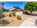 Charming home showcasing a tan stucco exterior, low-maintenance landscaping, and a two-car garage at 542 N Orlando Cir, Mesa, AZ 85205