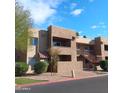 Inviting two-story exterior showcases balconies, desert landscaping, and a classic, Southwestern-style architectural charm at 5877 N Granite Reef Rd # 2257, Scottsdale, AZ 85250