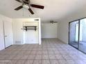 The living room has tile floors, two fans and sliding glass doors to the outside at 600 S Dobson Rd # 148, Mesa, AZ 85202