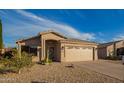 Charming single-story home with a two-car garage and low maintenance desert landscaping at 6853 S Russet Sky Way, Gold Canyon, AZ 85118