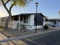 Charming home featuring mature trees, desert landscaping, covered parking and porch at 6960 W Peoria Ave # 212, Peoria, AZ 85345