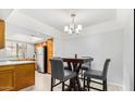 This cozy dining area features a modern chandelier and stylish gray chairs, perfect for intimate meals at 700 E Mesquite Cir # N125, Tempe, AZ 85288