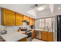 Bright kitchen with stainless steel appliances, a skylight, and generous counter space for cooking at 700 E Mesquite Cir # N125, Tempe, AZ 85288