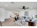 Open-concept living room featuring a comfortable sofa, leather chairs, modern rug and ceiling fan at 736 N Meadows Dr, Chandler, AZ 85224