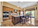 Gourmet kitchen boasts an island, stainless steel appliances, and adjacent dining area at 7500 E Pontebella Dr, Scottsdale, AZ 85266