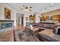 Spacious living room featuring a fireplace, open floorplan, and wood-look tile floors at 7500 E Pontebella Dr, Scottsdale, AZ 85266