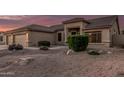 Home featuring a spacious garage, desert landscaping with shrubs and gravel at 8220 W Mariposa Grande Ln, Peoria, AZ 85383