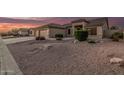 Home featuring a spacious garage, desert landscaping with shrubs and gravel at 8220 W Mariposa Grande Ln, Peoria, AZ 85383