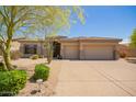 Charming single-story home featuring a well-manicured desert landscape and a spacious two-car garage at 9747 S 182Nd Dr, Goodyear, AZ 85338