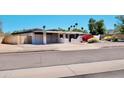 Single story home featuring desert landscaping and a two car garage with solar panels above at 11035 N 37Th St, Phoenix, AZ 85028