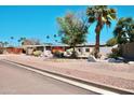 Single story home featuring desert landscaping and a two car garage with a courtyard wall at 11035 N 37Th St, Phoenix, AZ 85028