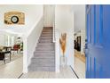 Open entryway featuring a staircase, white walls, and light wood-look flooring, creating a bright and inviting space at 1138 E Liberty Shores Dr, Gilbert, AZ 85234