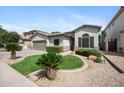 Beautiful single-story home featuring a well-maintained lawn and desert landscaping for low maintenance at 1748 E Cortez Dr, Gilbert, AZ 85234