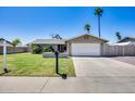 Charming single-story home featuring a well-manicured lawn, mature trees, and a two-car garage at 18642 N 13Th Ave, Phoenix, AZ 85027