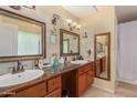 Bathroom with a double vanity, stylish mirrors, and ample counter space at 3121 W Greenway Rd, Phoenix, AZ 85053