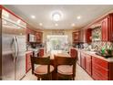 A spacious kitchen with stainless steel appliances, a center island, and abundant wood cabinetry at 3121 W Greenway Rd, Phoenix, AZ 85053