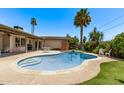 Backyard pool surrounded by lush greenery, with seating and lounging areas, under a clear blue sky at 425 E Del Rio Dr, Tempe, AZ 85282