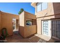 Private patio area with stucco walls, offering a secluded outdoor space at 10 E Betty Elyse Ln, Phoenix, AZ 85022