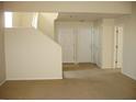 Inviting entryway showcasing neutral walls, tan carpeting, and staircase leading to the upper level at 11218 W Glenrosa Ave, Phoenix, AZ 85037