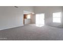 Spacious living room featuring carpet floors and backyard access at 11218 W Glenrosa Ave, Phoenix, AZ 85037