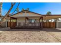 Cozy home exterior featuring a covered porch, carport, and low maintenance landscaping at 115 S Stardust Ln, Apache Junction, AZ 85120