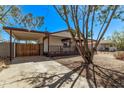 Charming home with a covered porch, carport, and low-maintenance landscaping at 115 S Stardust Ln, Apache Junction, AZ 85120