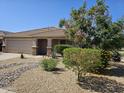 Charming single-story home featuring desert landscaping, a two-car garage, and a covered entrance at 11760 N 153Rd Ave, Surprise, AZ 85379