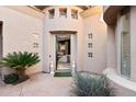 Grand home entrance with decorative columns, statues, and well-manicured plants at 15240 N Clubgate Dr # 137, Scottsdale, AZ 85254
